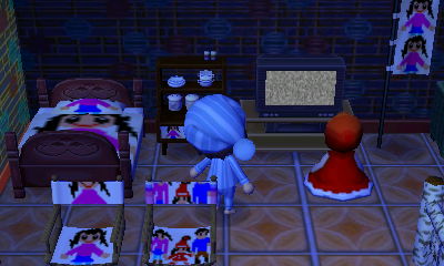 A doll watches static on a TV in the horror themed dream town of Aika Village.
