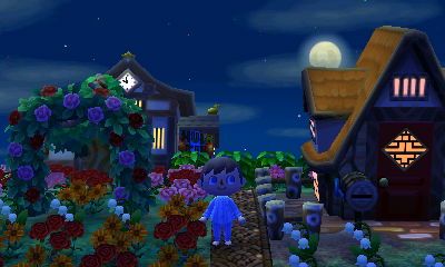 Houses and a flower arch in the New Leaf dream town of Hula Key.