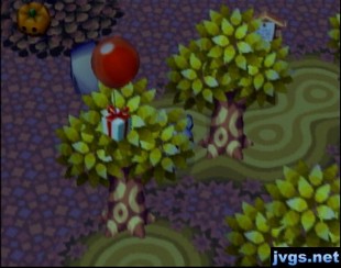 A balloon present on a red balloon lands in a golden tree.