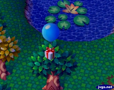 A balloon present gets caught in a tree in Animal Crossing on Nintendo GameCube.