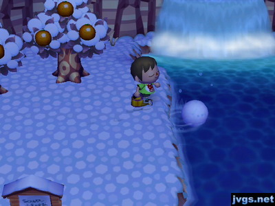 Pushing a snowball into the river.