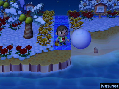 A very large snowball on the beach.