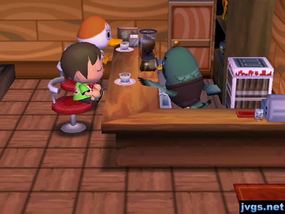 Brewster hands me a cup of coffee as I sit next to Pompom.