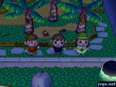 Wendy, Jeff, and Yann standing in the bug room at the museum. A scorpion and tarantula are battling behind us.