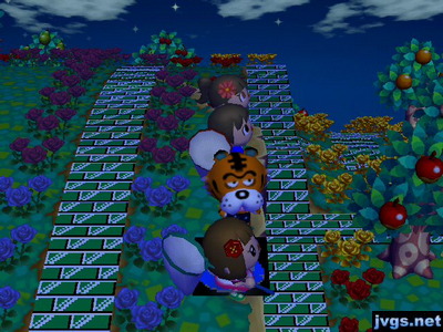 Wendy, Jeff, and Yann standing at the edge of a cliff, while Rowan stares at Yann.