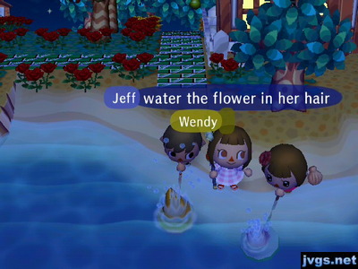 Jeff and Yann splash their nets in the ocean, trying to wet Wendy, who is standing between them.