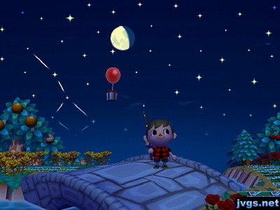 The clear night sky, with a present floating by, attached to a red balloon.