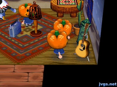 Three pumpkin heads in Amelia's house, two of them watching the gyroid.