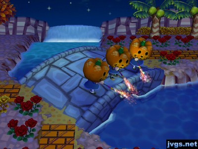 Yann, Jeff, and Megan, all wearing pumpkin heads and dressed as Jack, firing off roman candles while standing on a bridge.