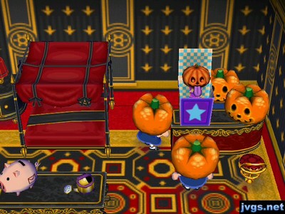 Three pumpkin heads playing with the jack in the box, which itself has a pumpkin head.