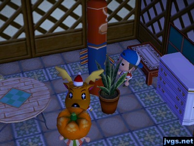 Jeff stands at the totem pole as Yann talks to Jingle.