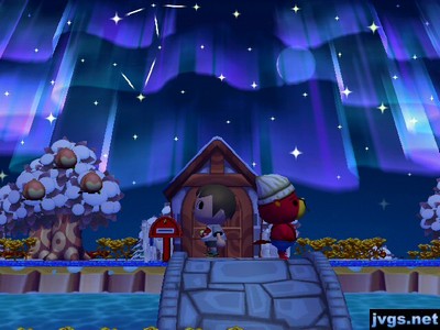 Jeff and Pascal, standing back-to-back on the bridge, with the northern lights overhead.