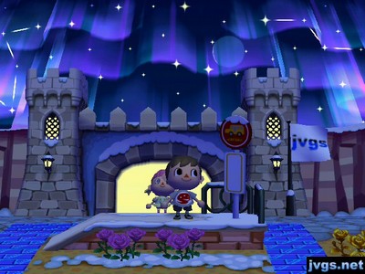 Megan enters the castle-shaped gate as the northern lights are visible overhead.