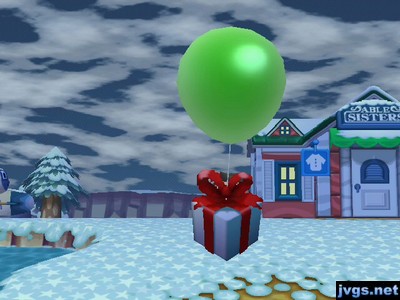 A present on a green balloon, appearing large on screen.