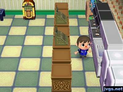 A kitchen with some counters and cash registers, perhaps part of a restaurant.