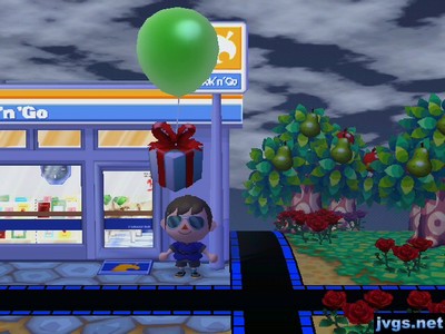 A green balloon present flies above my head outside of Nook 'n' Go.