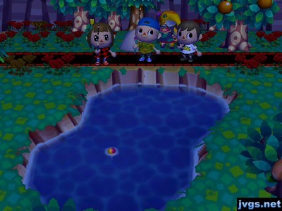 Anabelle sneaks up behind Yann, Jon, and Jeff at the pond.