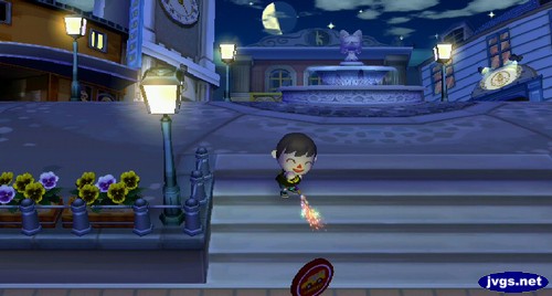 Jeff sets off a Roman candle in an empty city at night in Animal Crossing: City Folk.