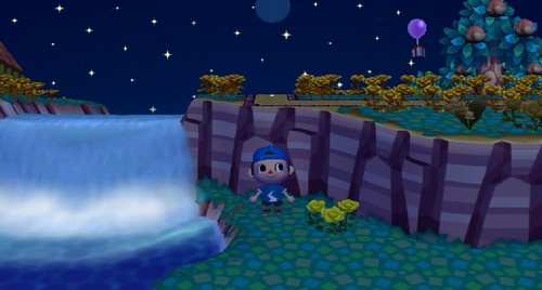 Standing by the waterfall as a balloon present flies by in the distance.