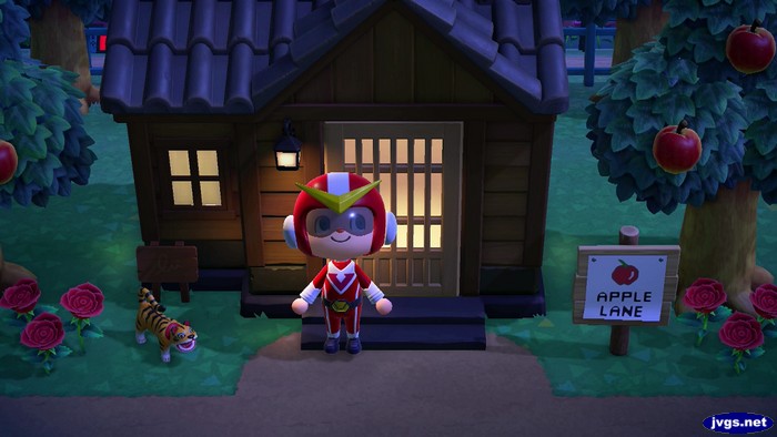 A paper tiger sits outside the house of Tybalt (a tiger) in Animal Crossing: New Horizons.