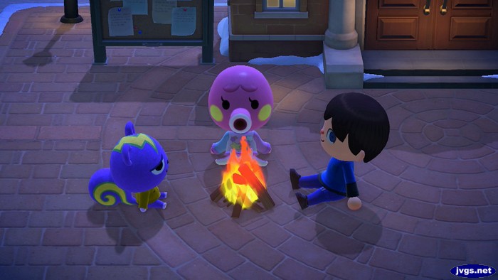 Static, Marina, and Jeff sit by the campfire at Resident Services.