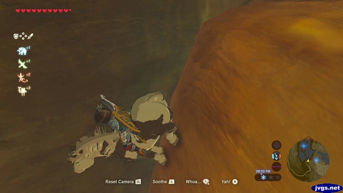 Link, on a horse, faces down the side of a cliff.