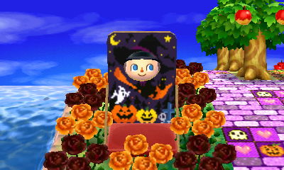 A witch face-cutout standee in the dream town of Joy.