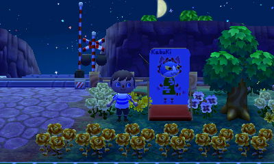 Tom the cat sticking his face through the Kabuki cutout standee.