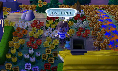 A lost item on the ground among flowers.