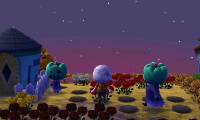 Aurora and Big Top dressed up in robes and green pumpkin heads.