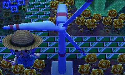 Beth standing under the wind turbine.