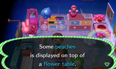 Some peaches is displayed on top of a flower table.