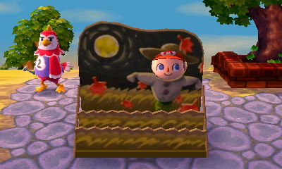 Benedict gives me a funny look as I poke my face through the scarecrow face cutout standee for the autumn moon.