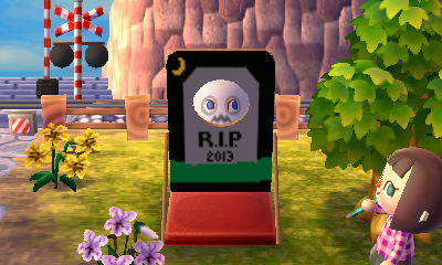 Poking my face through my gravestone face-cutout standee while wearing a ghost mask.