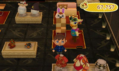 Gabi hides behind a sweets chair in GracieGrace.