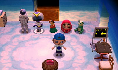 Dolls, a bear, and a spaceman lined up in the SpotPass home of Ray from Jojo