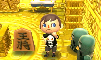 A shogi piece on display in my golden room.