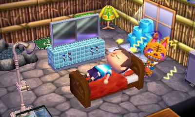 Tabby walks around shivering as I lie in her bed.