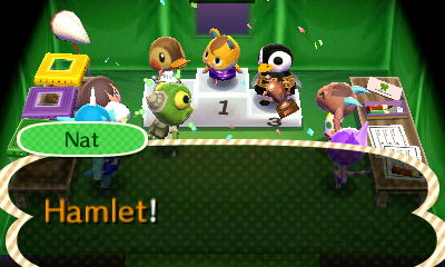 Nat proclaims Hamlet the winner of the Bug-Off competition at the winners' ceremony.