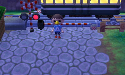 A train goes by at the railroad crossing.