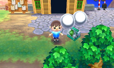 A silver slingshot floats by on two silver balloons.