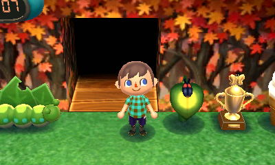 My firefly lamp and gold bug trophy, on display in my New Leaf house.