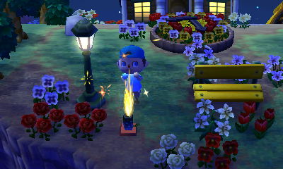 Setting off a fountain firework in the park.