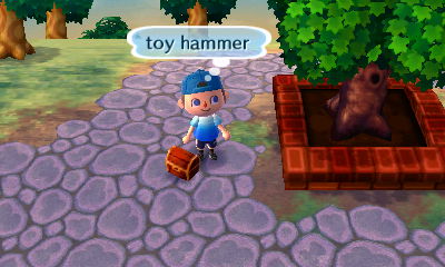 My toy hammer sitting near the town tree.