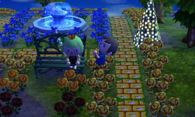 Beth sits on the bench with a butterfly flying over her head.