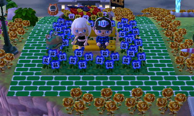 Beth and Jeff sitting on the bench, with Camofrog walking by.