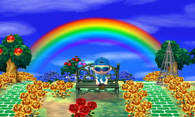 I sit on a metal bench with a rainbow in the sky behind me in Animal Crossing: New Leaf.