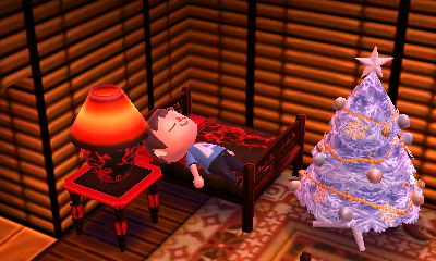 Sleeping near my white festive tree in Animal Crossing: New Leaf.