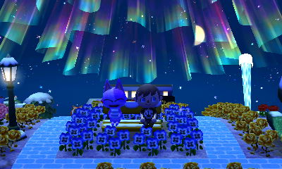 Bob and Jeff sit on the bench near the geyser.