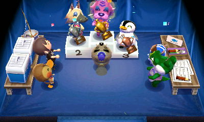 Claudia stands atop the winners' podium during the fishing tournament's winners ceremony.